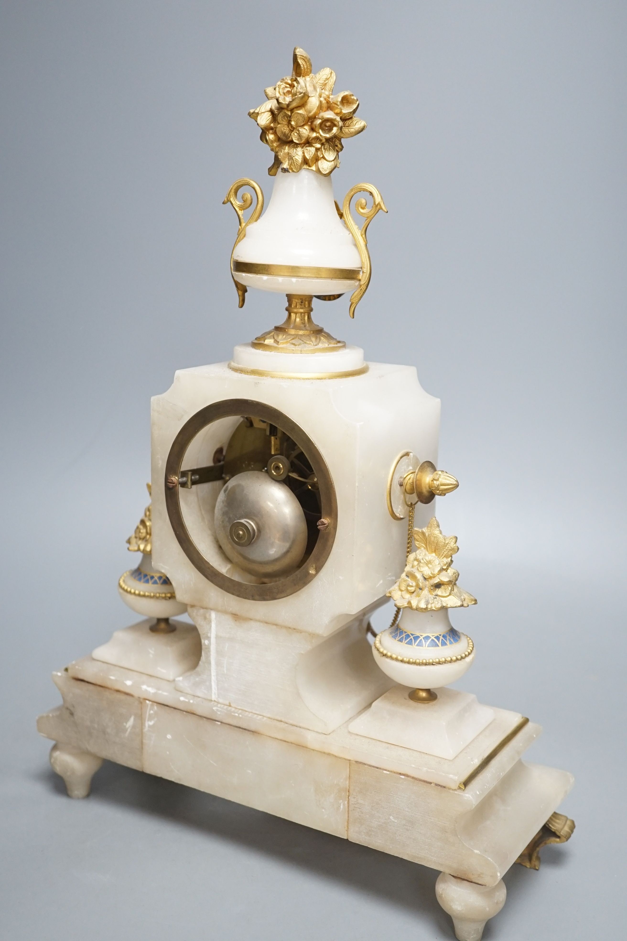 A late 19th century French alabaster and ormolu mounted mantel clock with key and pendulum - 39cm tall